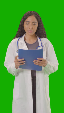 Vertical-Video-Portrait-Of-Female-Doctor-In-White-Lab-Coat-With-Stethoscope-Against-Green-Screen-4